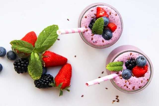 Refreshing berry smoothie in glasses with mint garnish