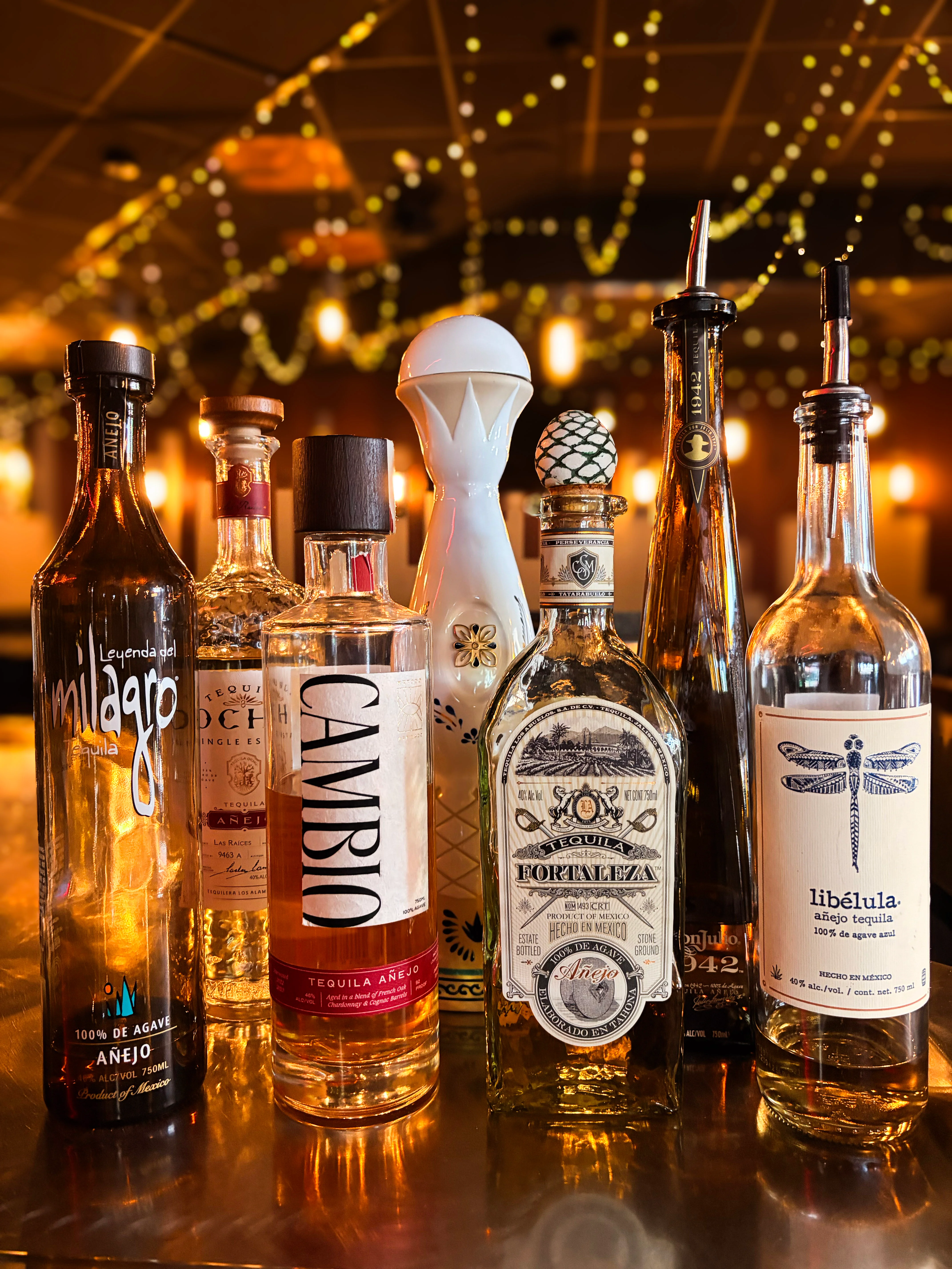 Selection of premium tequila bottles on a bar counter
