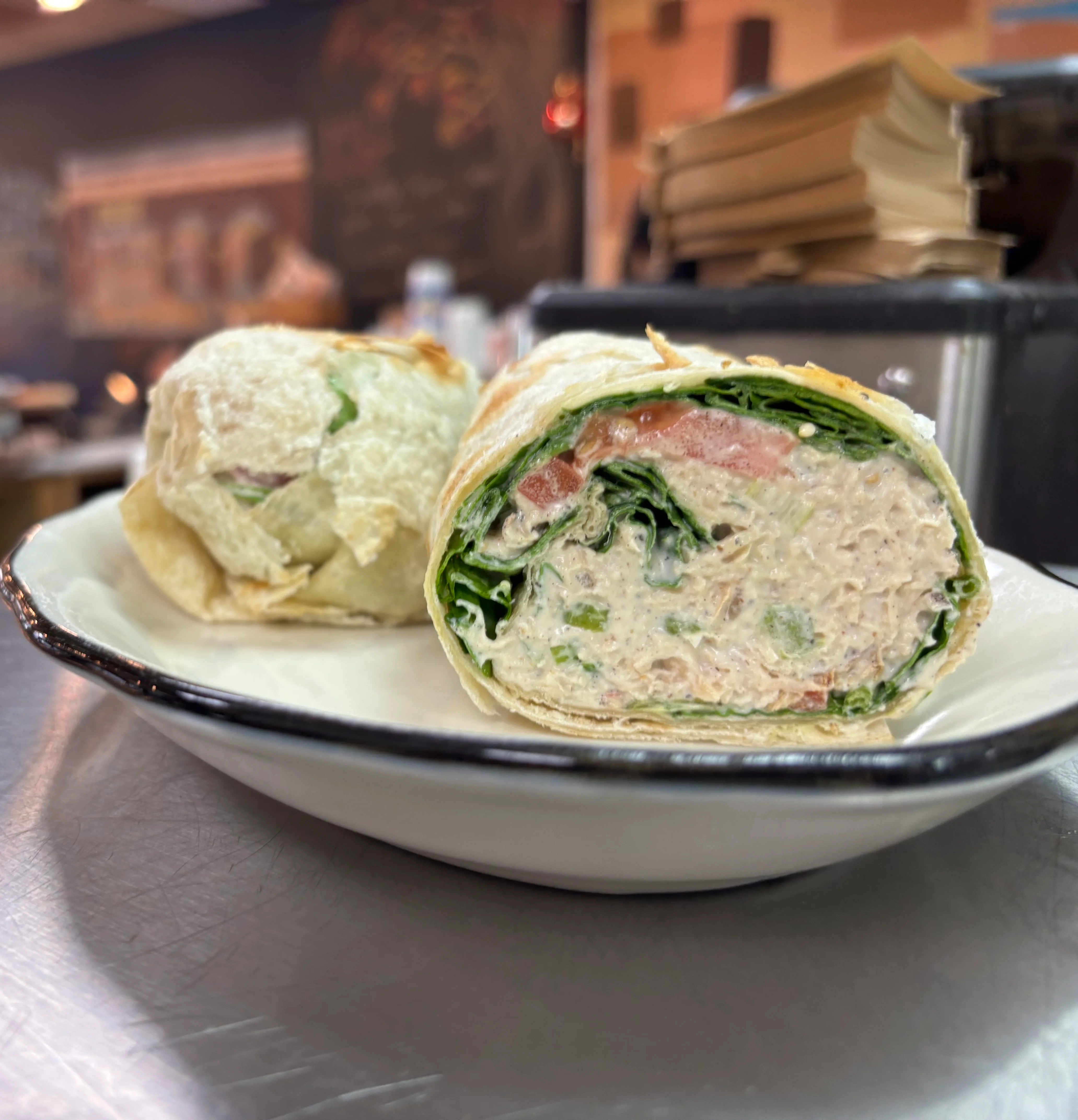 Fresh chicken wrap with greens and tomatoes