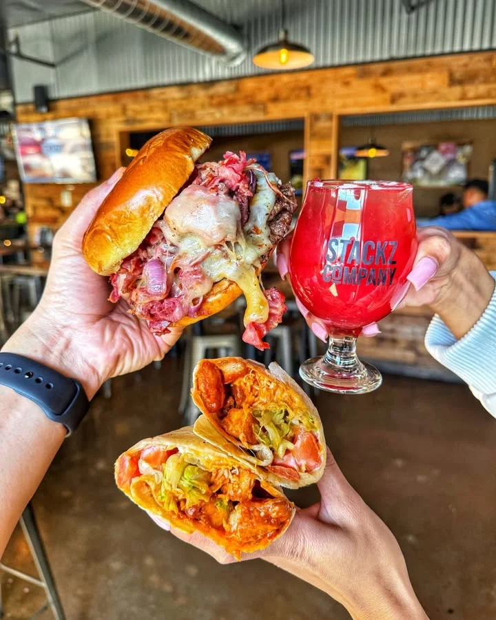 50/50 Burger with beef and bacon blend patty topped with melted cheese on brioche bun 