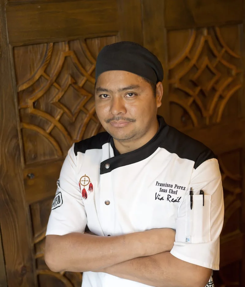 Sous chef posing confidently in a restaurant kitchen