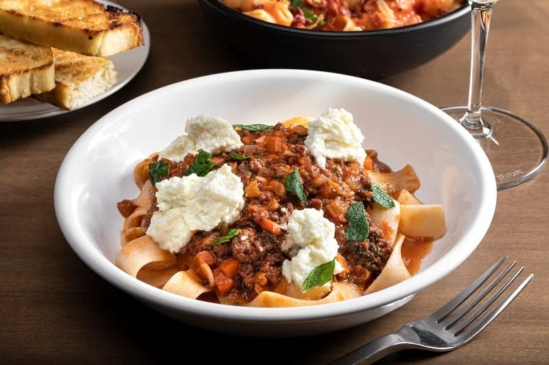 Italian pappardelle with meat sauce and ricotta