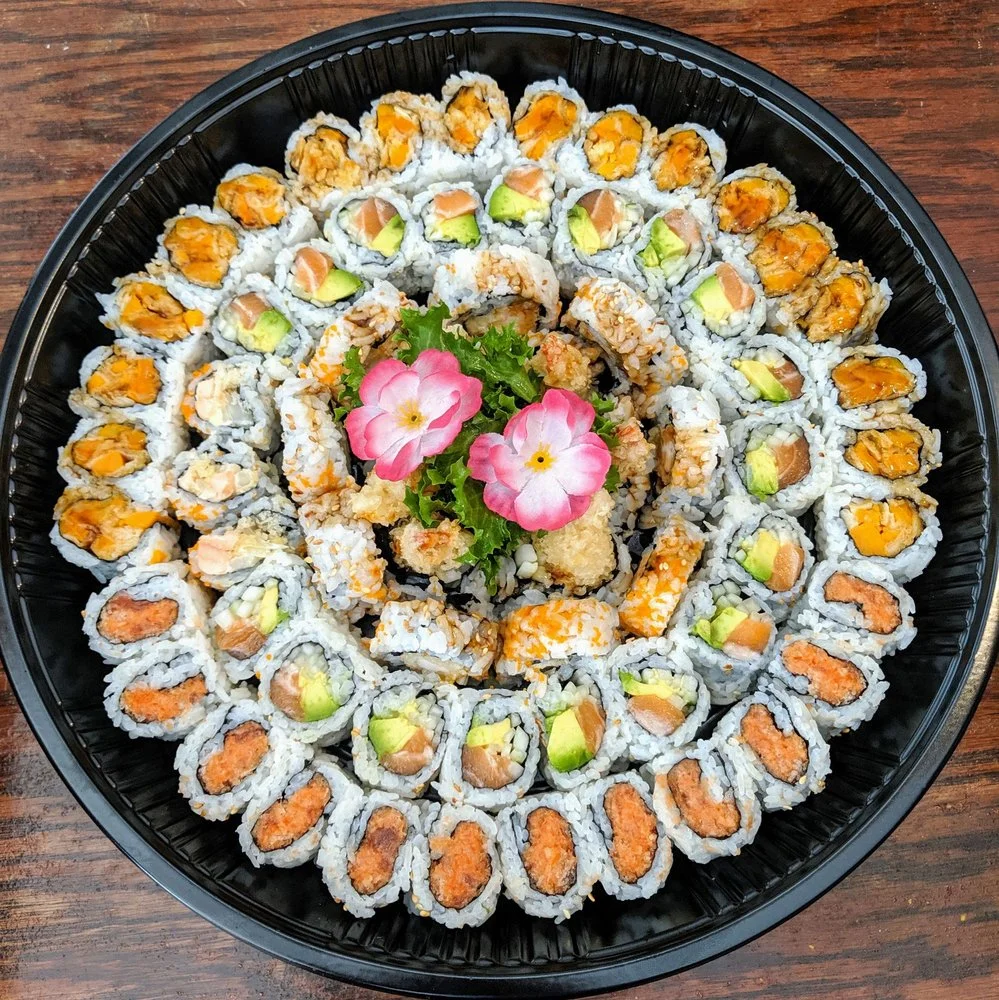 Assorted sushi platter featuring various rolls and garnishes