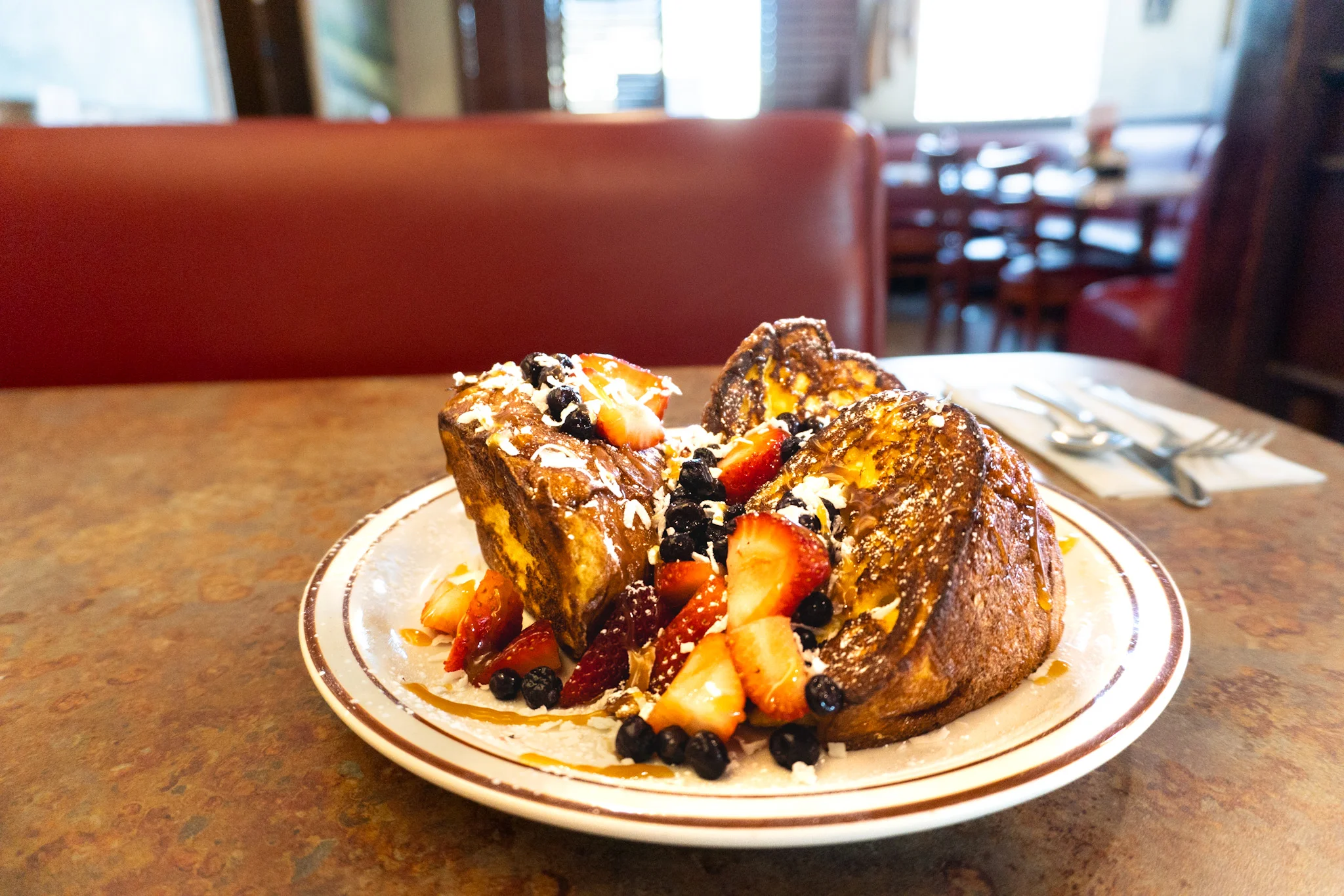 French toast topped with fresh berries and whipped cream