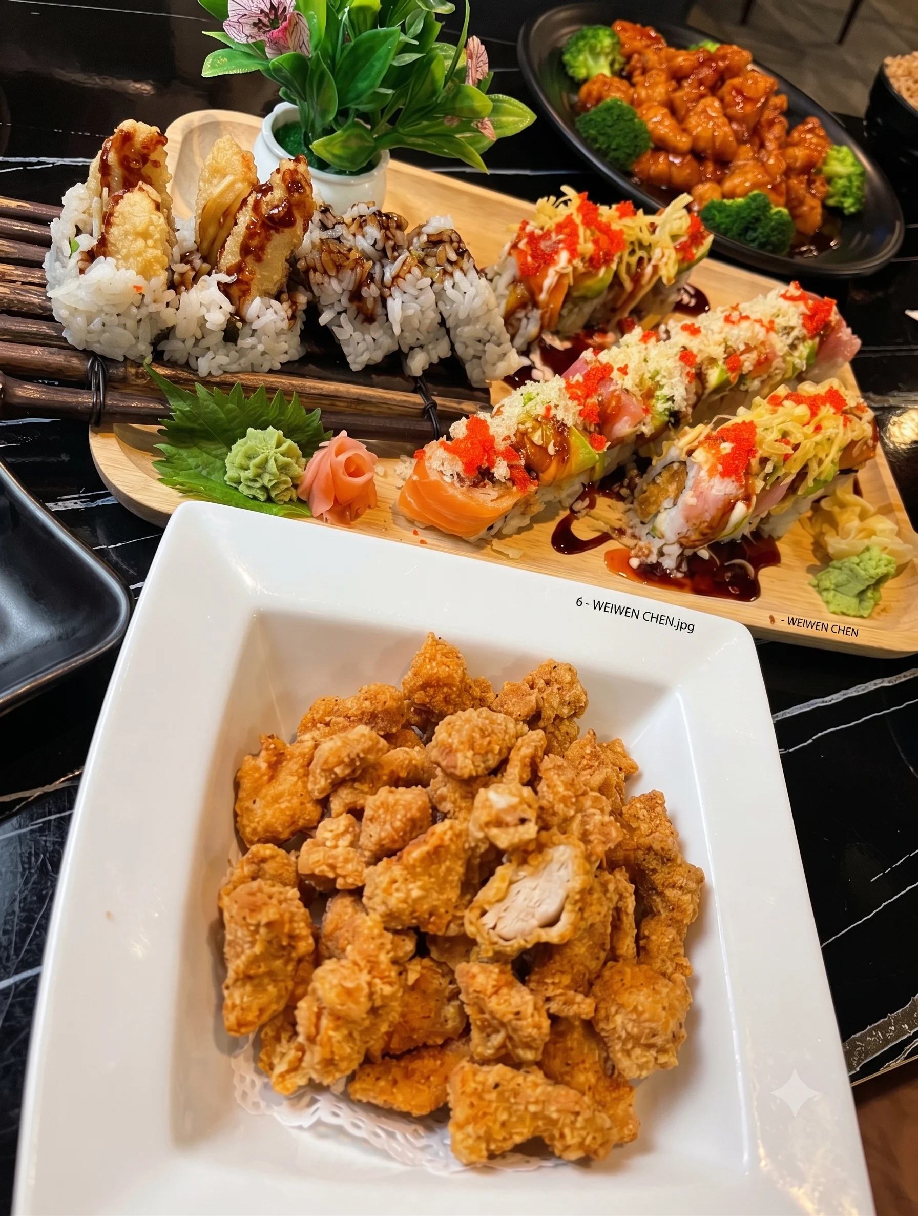 Assorted sushi platter with tempura rolls and crispy chicken