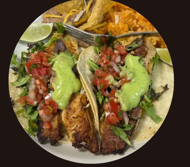 Delicious fish tacos with fresh toppings and sides