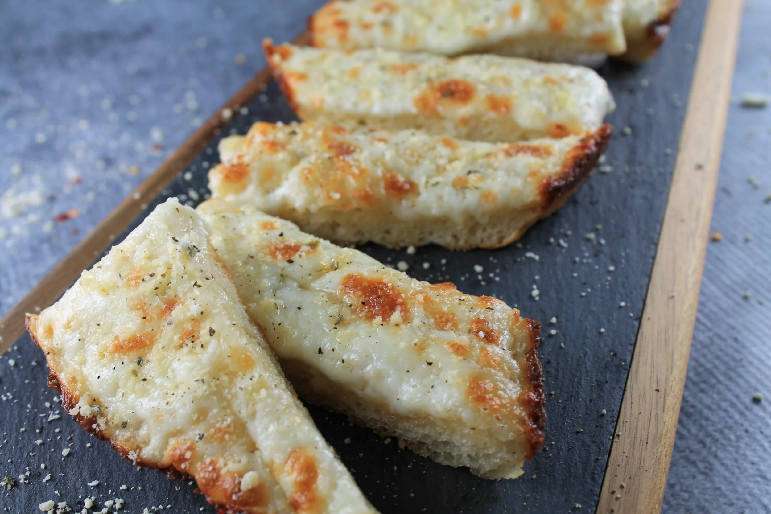 Delicious cinnamon bites drizzled with icing on a white plate.