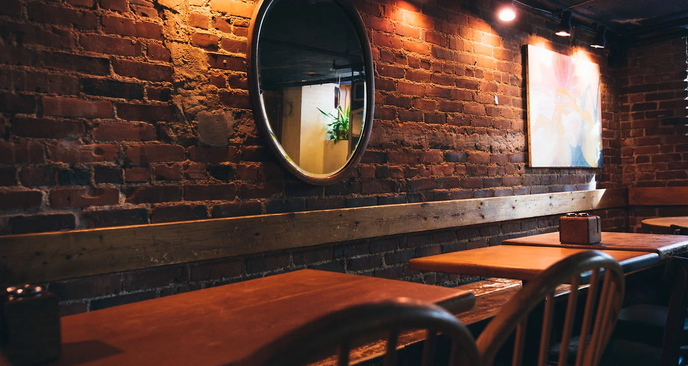Cozy restaurant interior with exposed brick and warm lighting