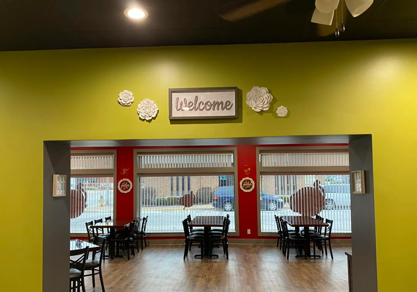 Welcoming restaurant interior with green walls and cozy seating