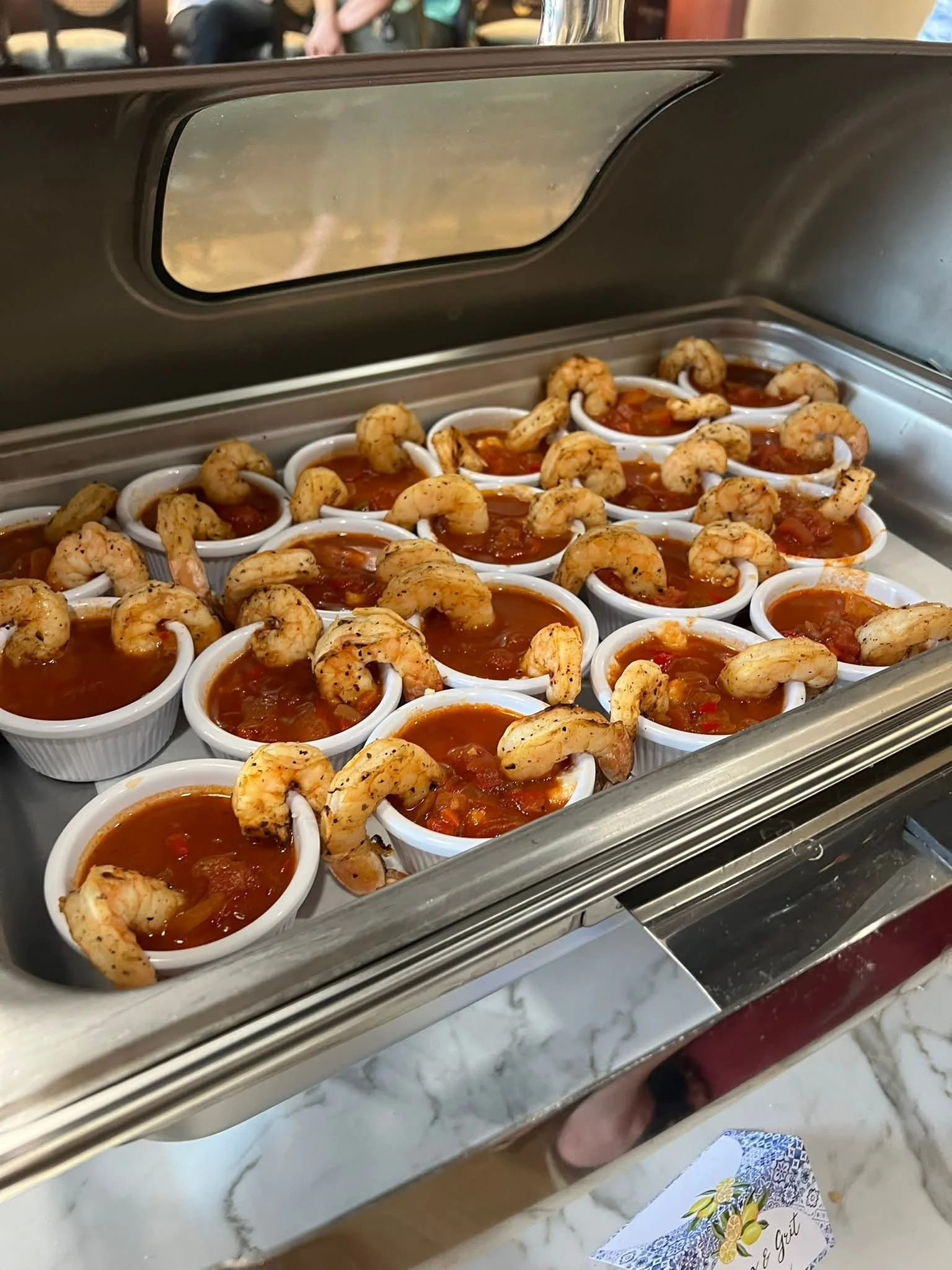 Shrimp cocktail served in individual cups with spicy sauce