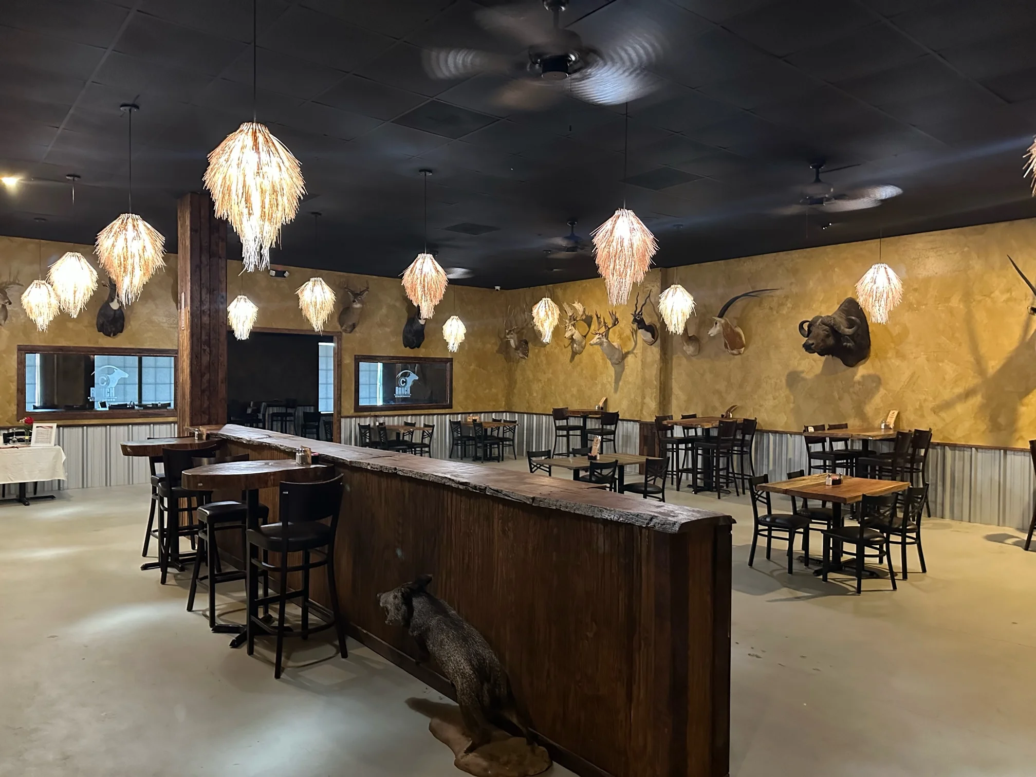 Rustic restaurant interior with unique lighting and taxidermy decor