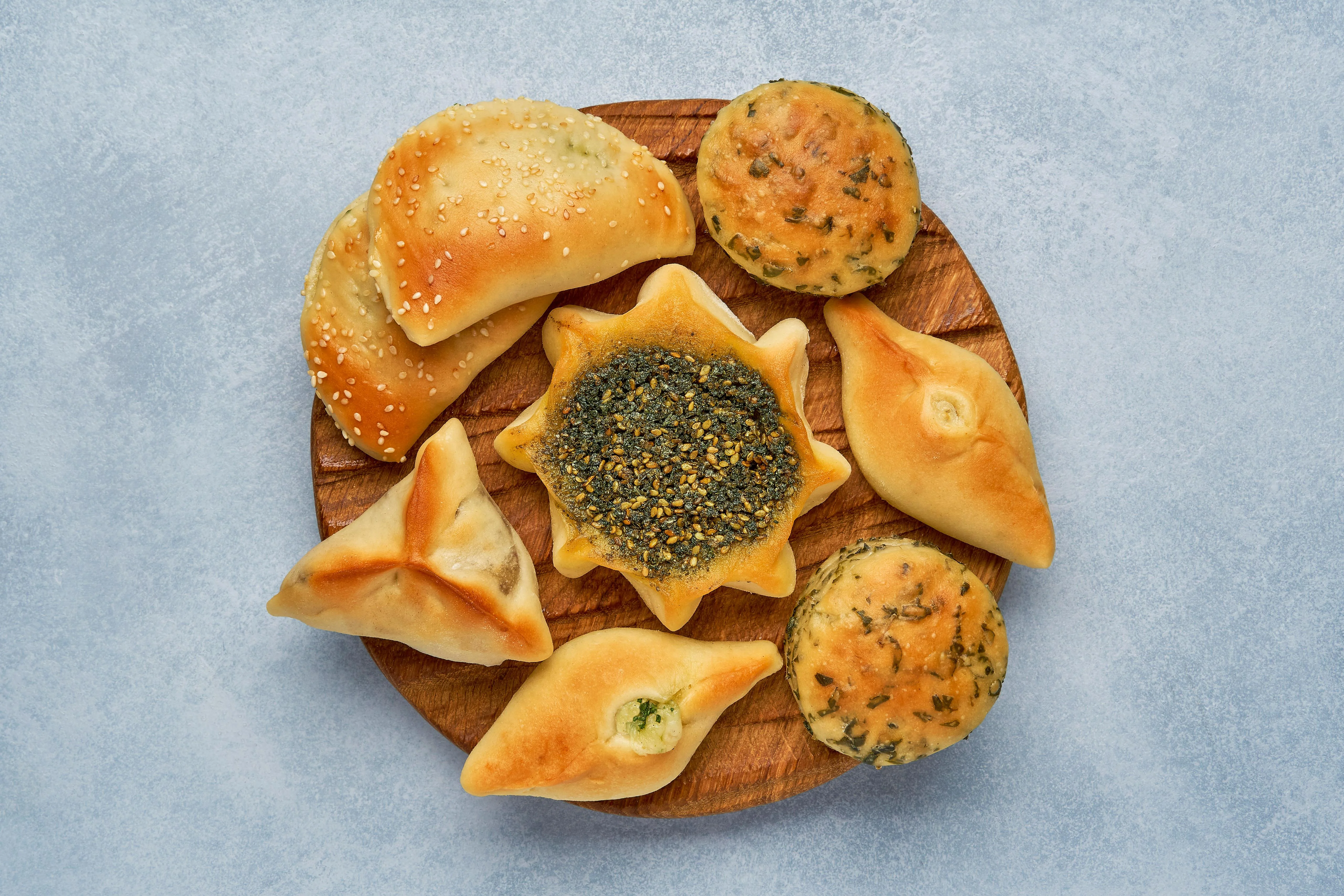 Assorted Middle Eastern pastries on a wooden platter
