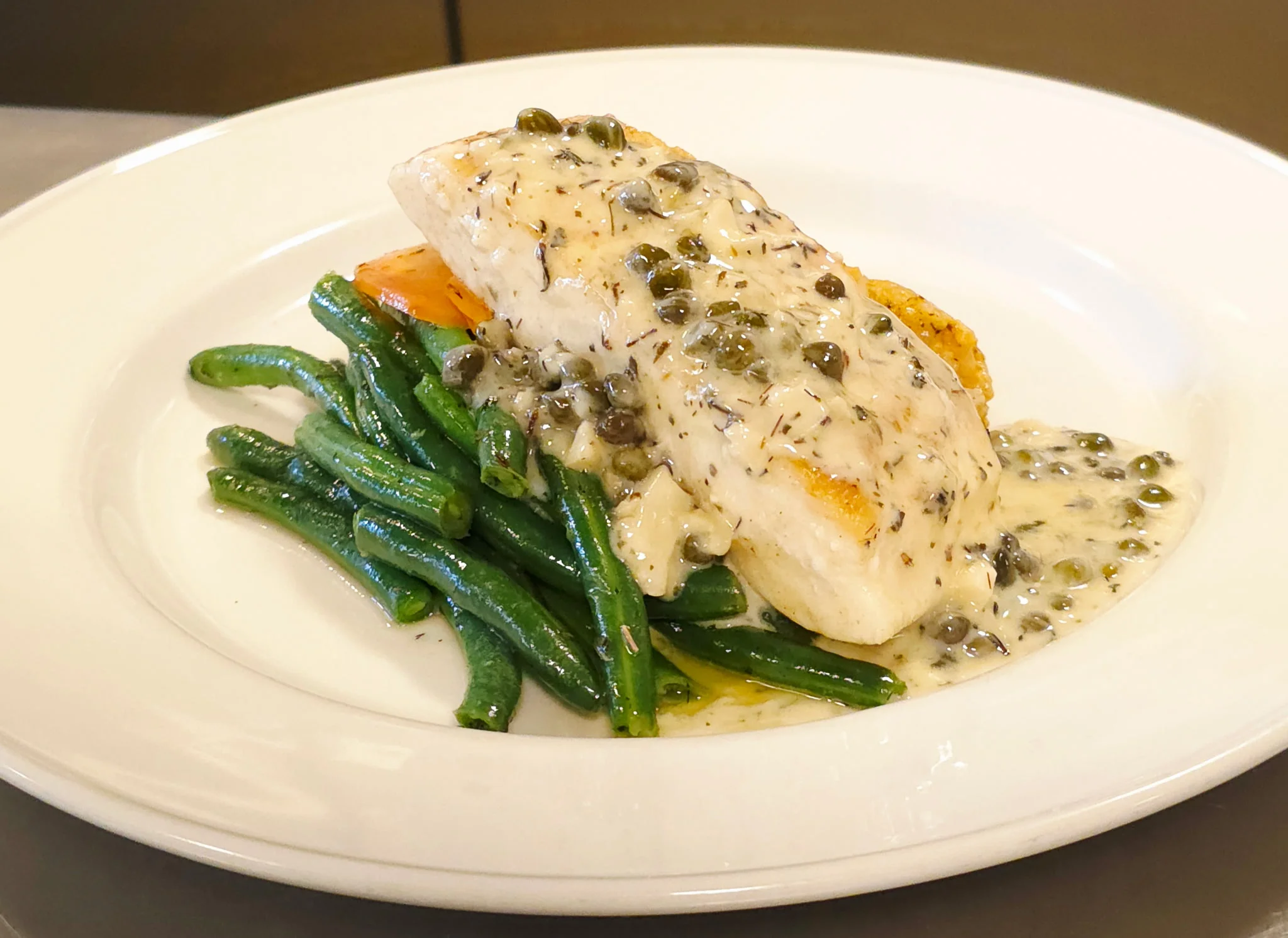 Pan-seared fish with creamy caper sauce and green beans