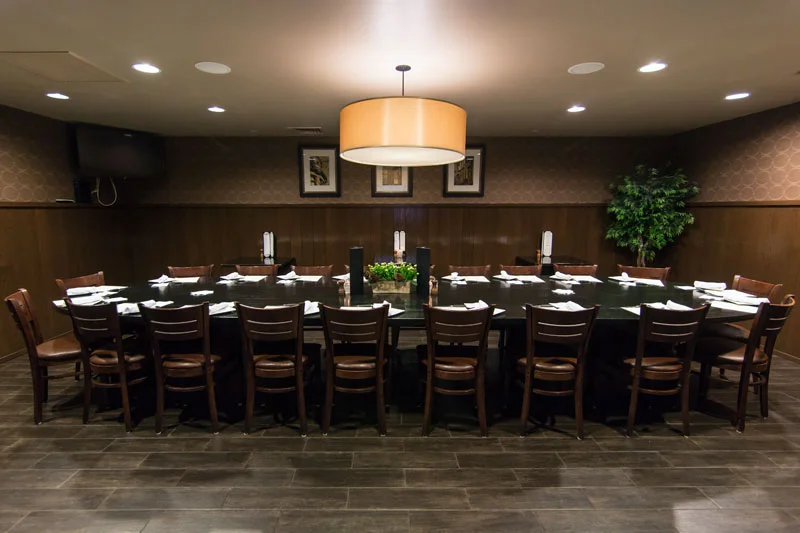 Elegant private dining room with a large table and warm lighting