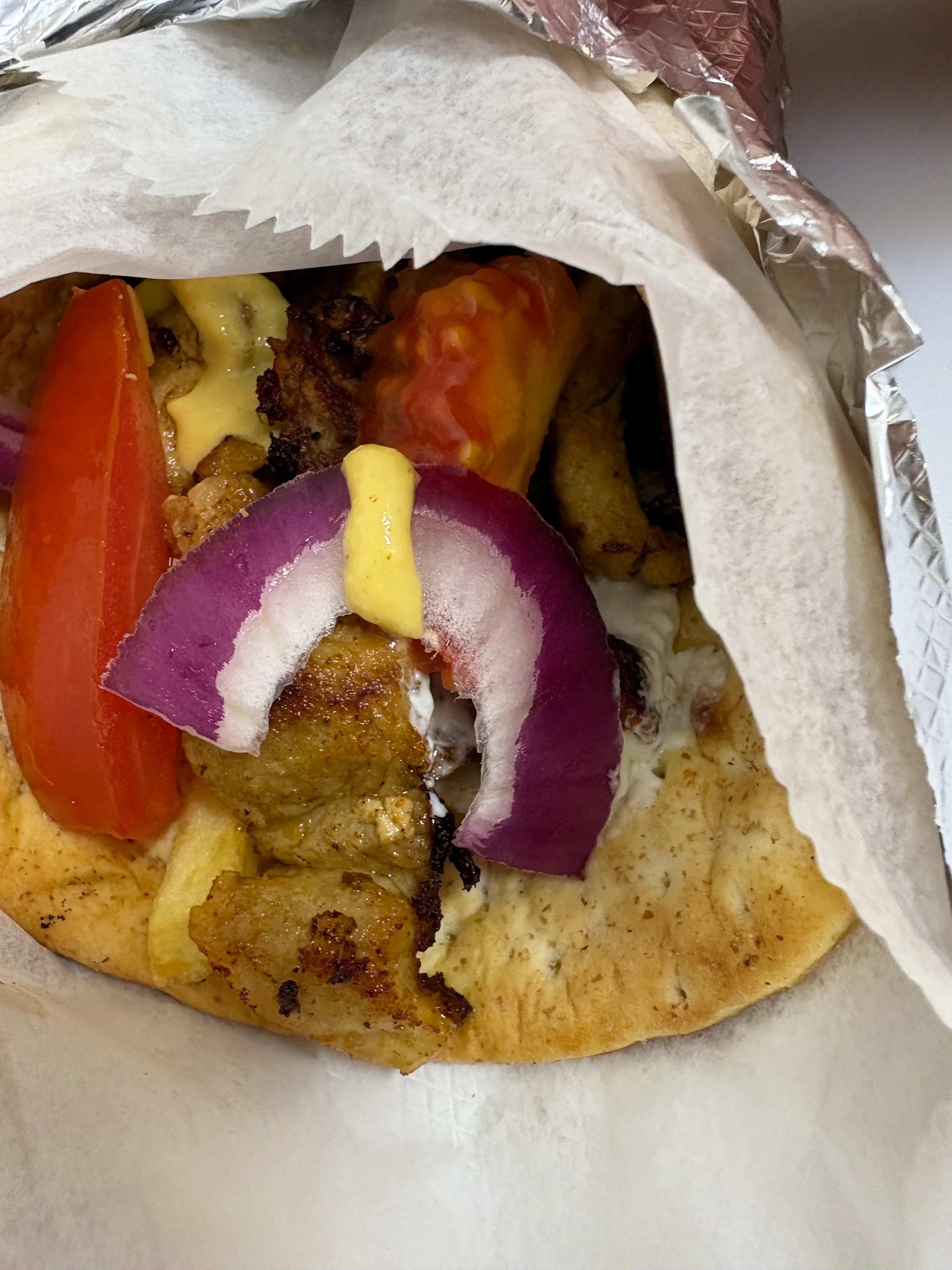 Delicious shawarma wrap with fresh vegetables and sauces