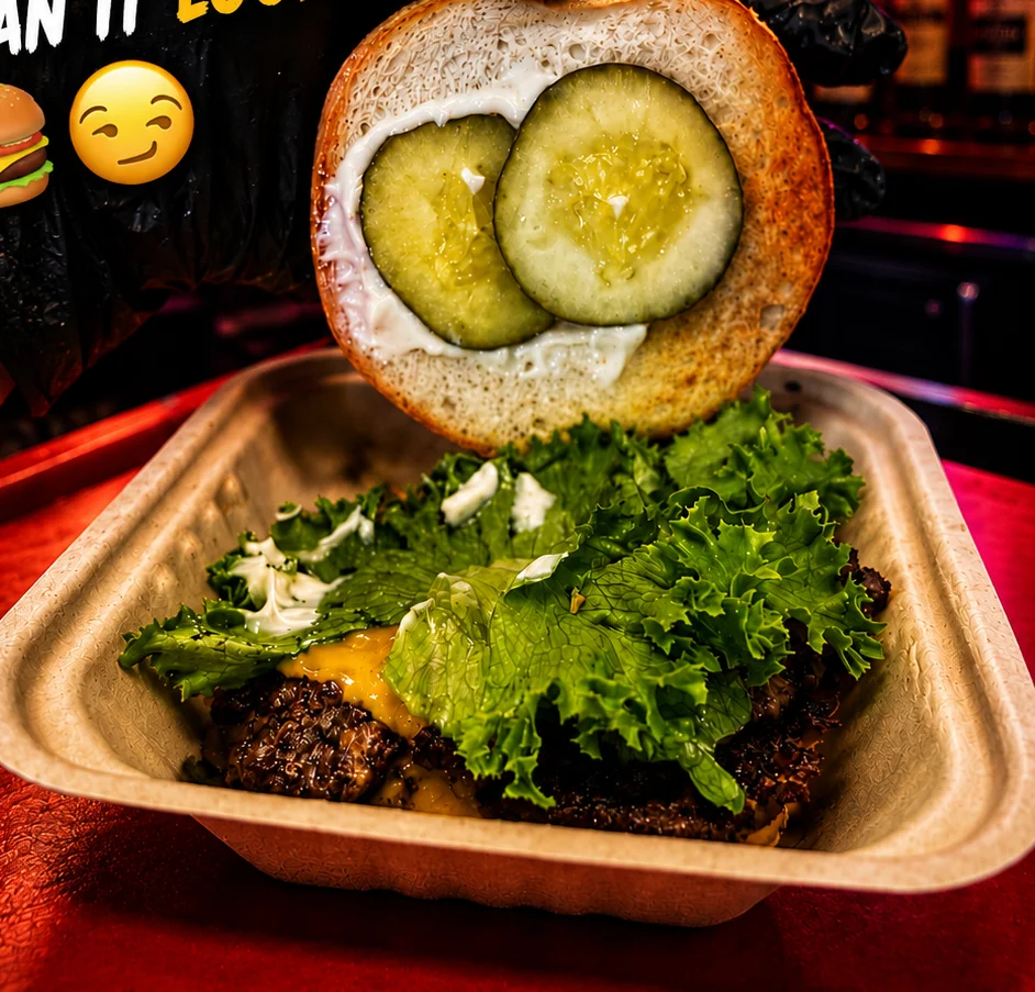 Juicy burger with lettuce and pickles in a vibrant restaurant setting