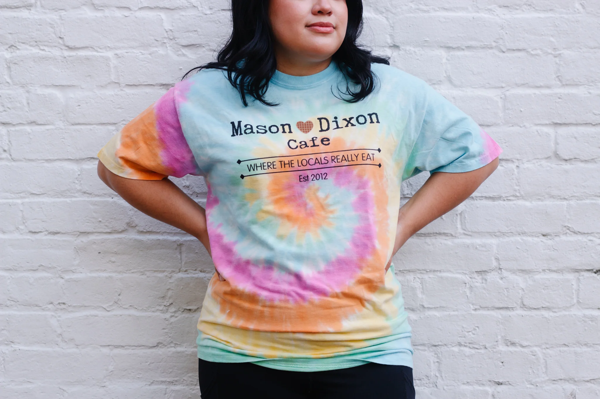 Person wearing a tie-dye shirt from Mason Dixon Cafe