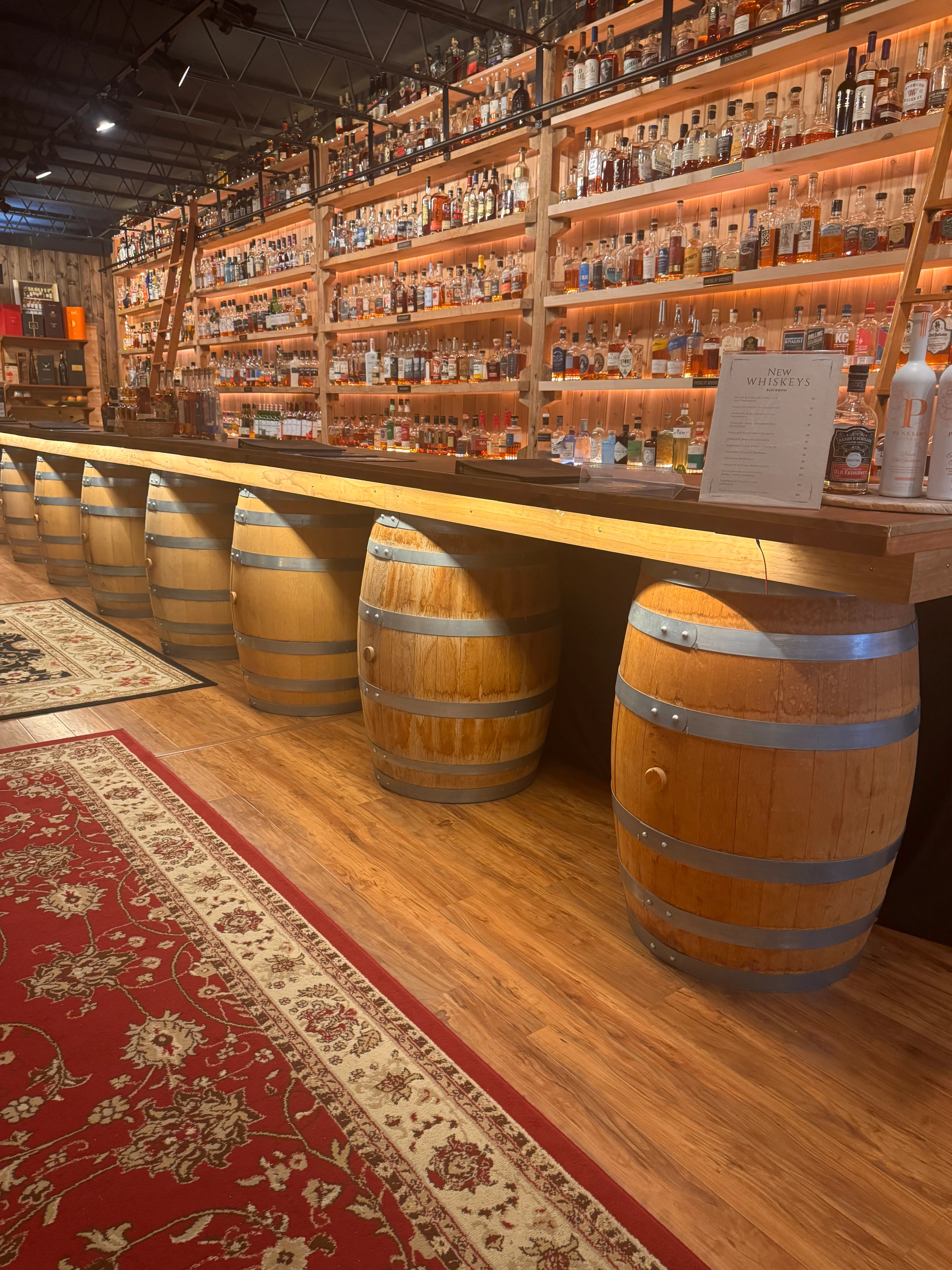 Stylish bar with whiskey bottles and wooden barrels