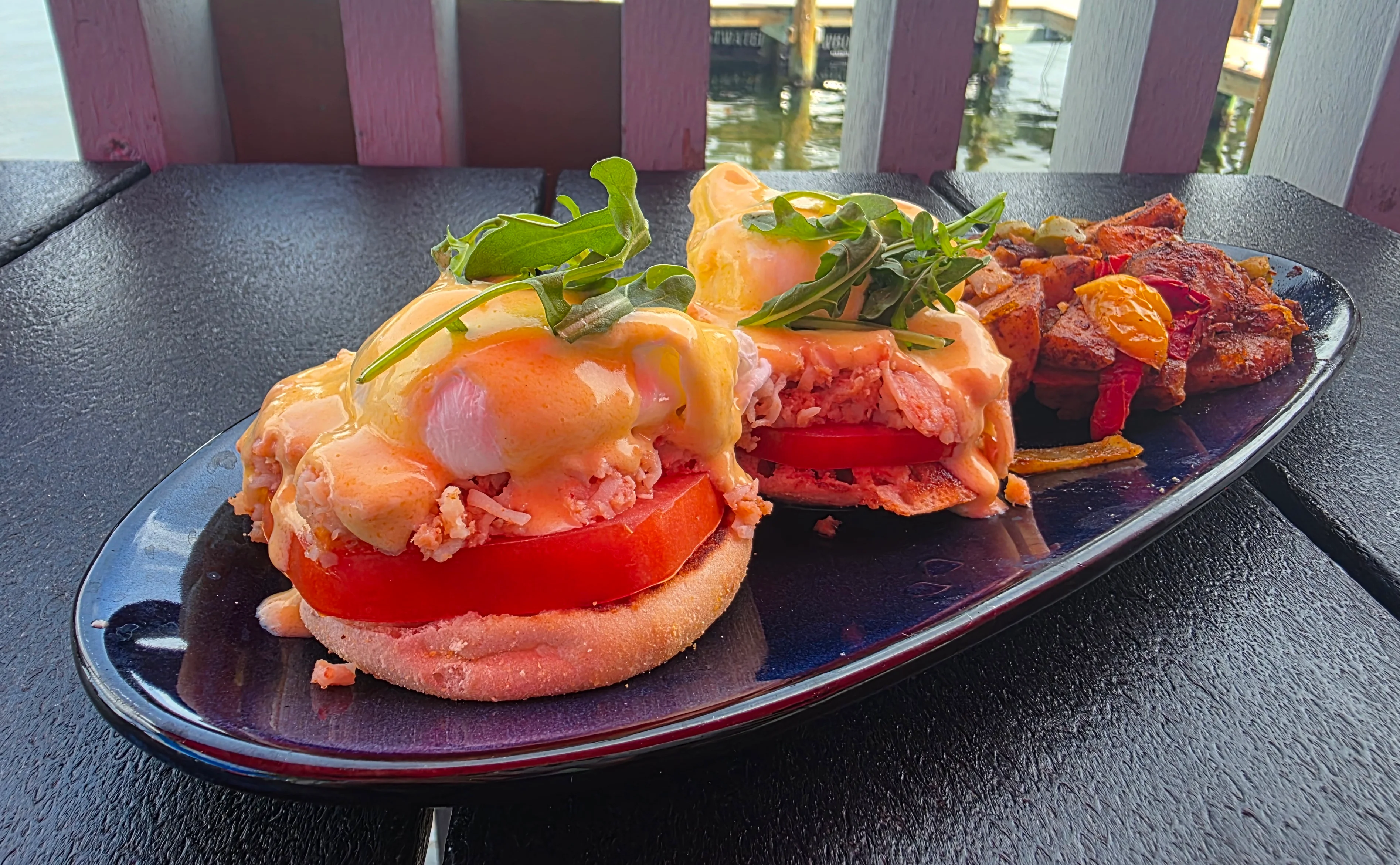 Eggs Benedict with crab and arugula on a toasted English muffin