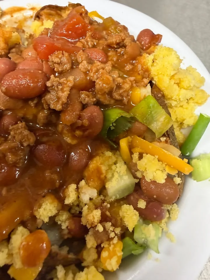 Hearty chili con carne served with cornbread