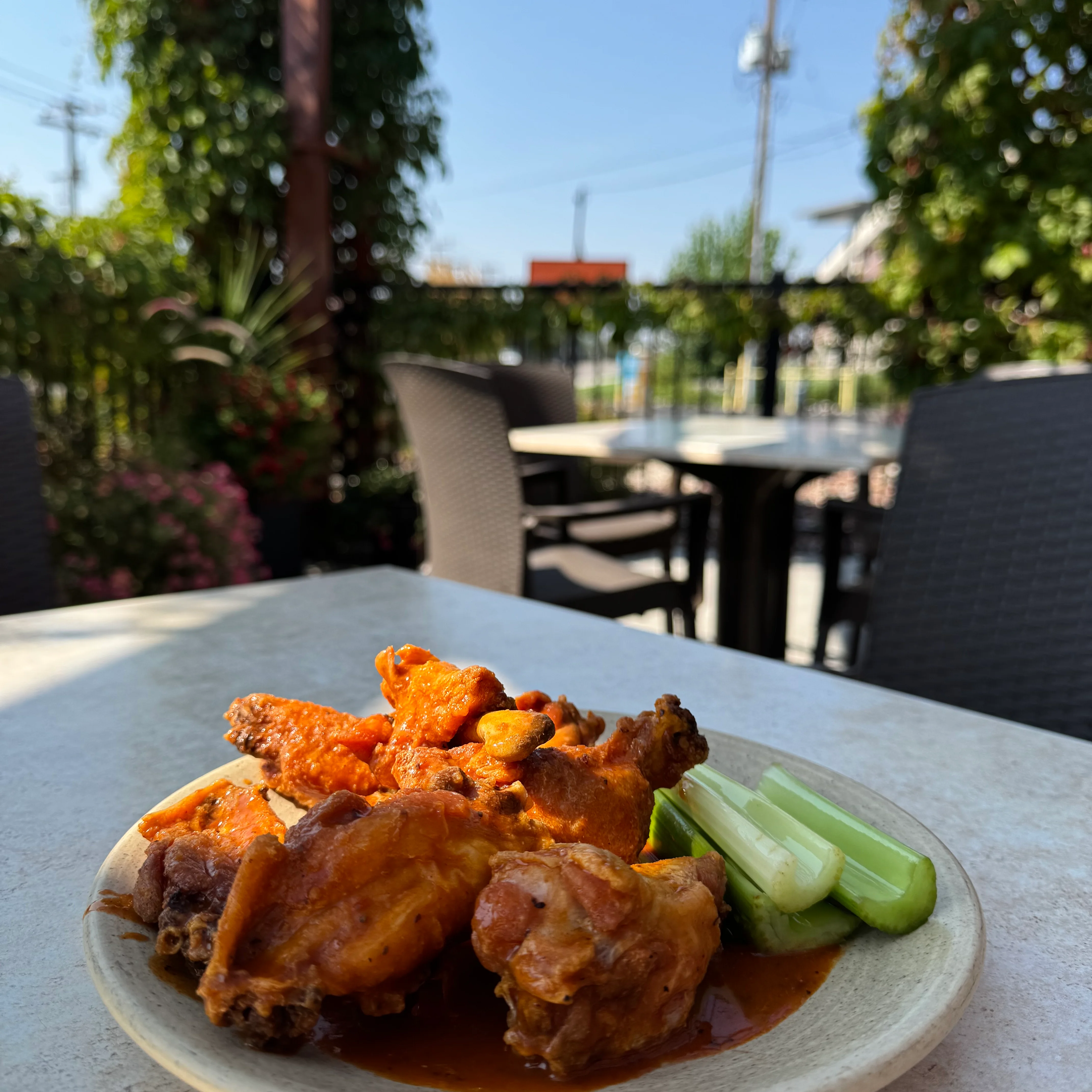 Spicy buffalo wings served with lime wedges