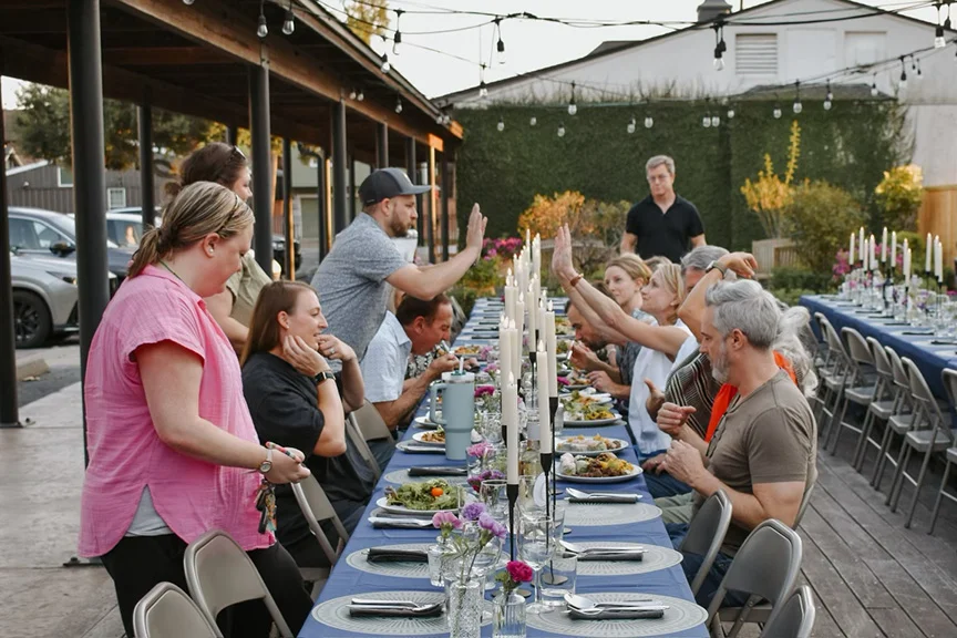 Outdoor dining setup with guests enjoying a meal together