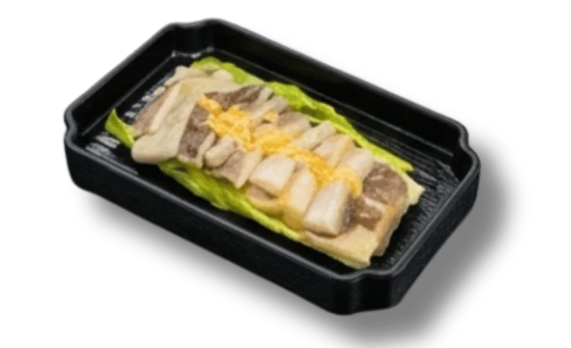 Sliced fish on a bed of lettuce in a black takeout container.