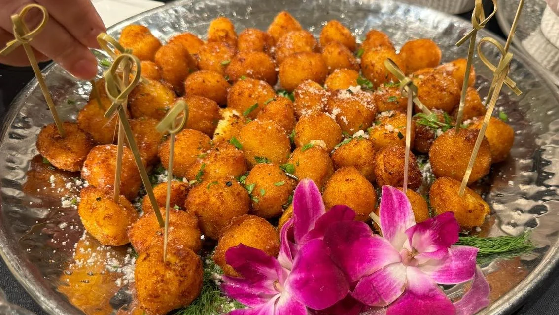 Asian inspired chicken meatballs topped with sweet chili sauce, scallions, and cilantro for a catering appetizer in Mount Kisco