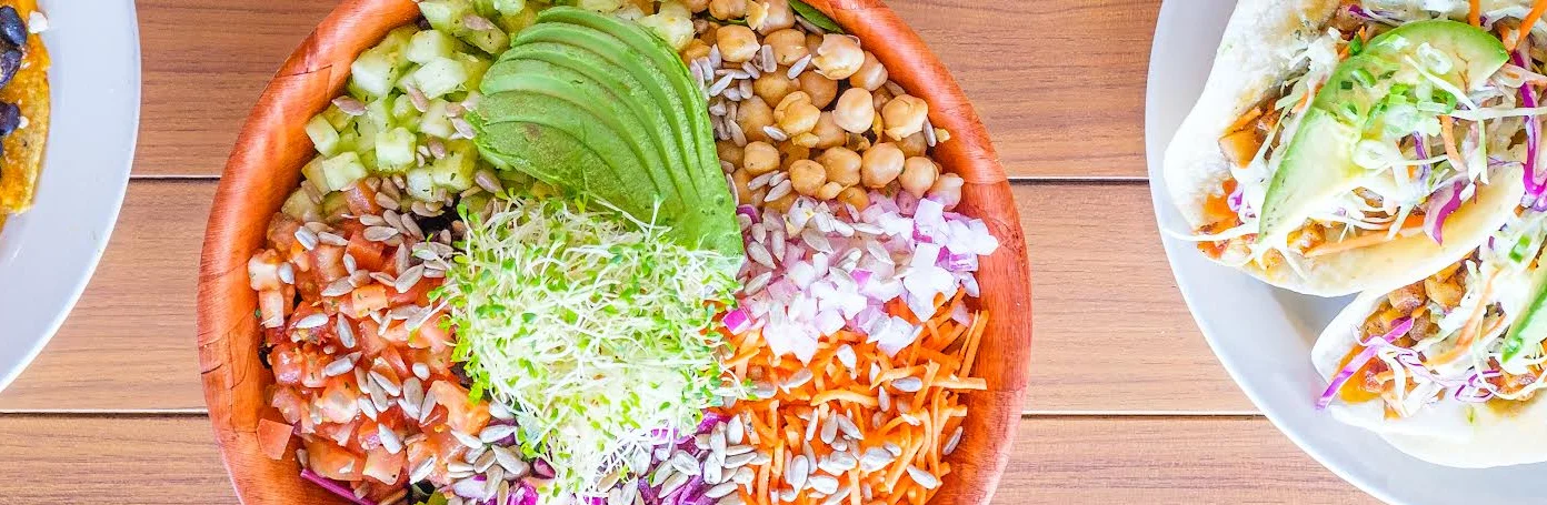 Colorful Mexican platter with tacos and a fresh salad bowl