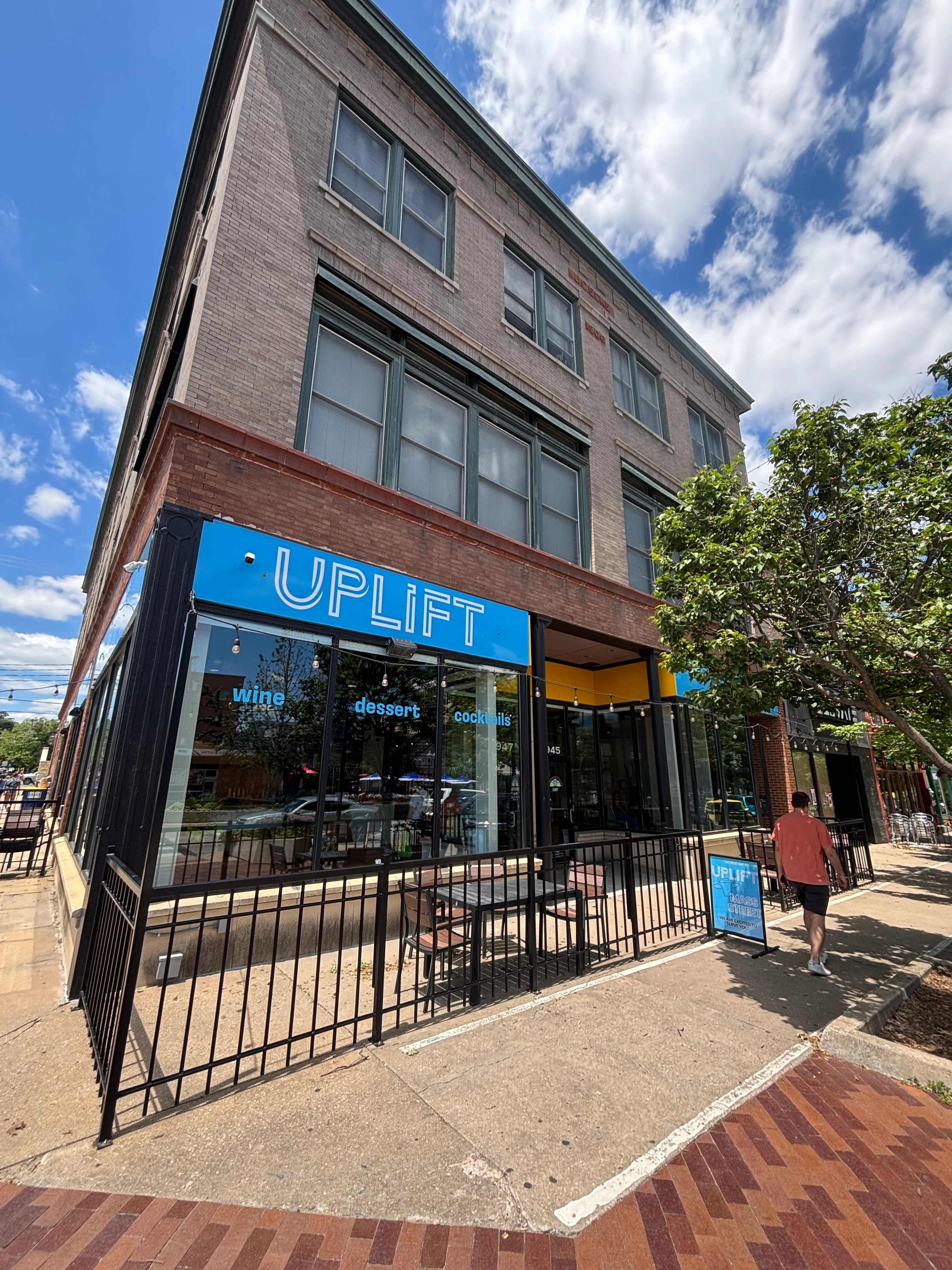 Exterior view of UPLIFT restaurant with outdoor seating