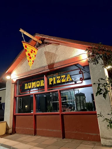 Exterior of Rumor Pizza restaurant at night