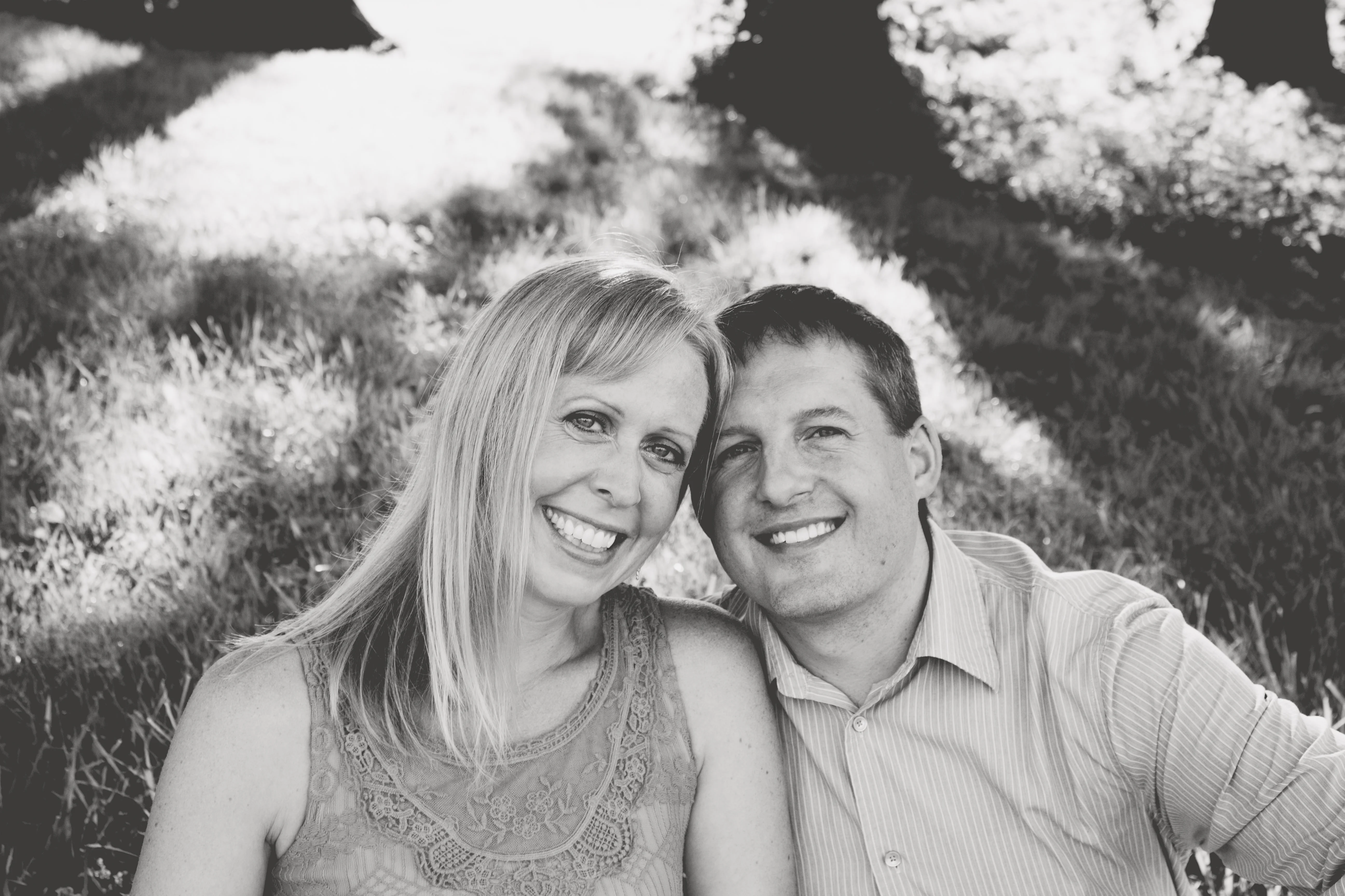 Couple smiling together in a sunlit park setting