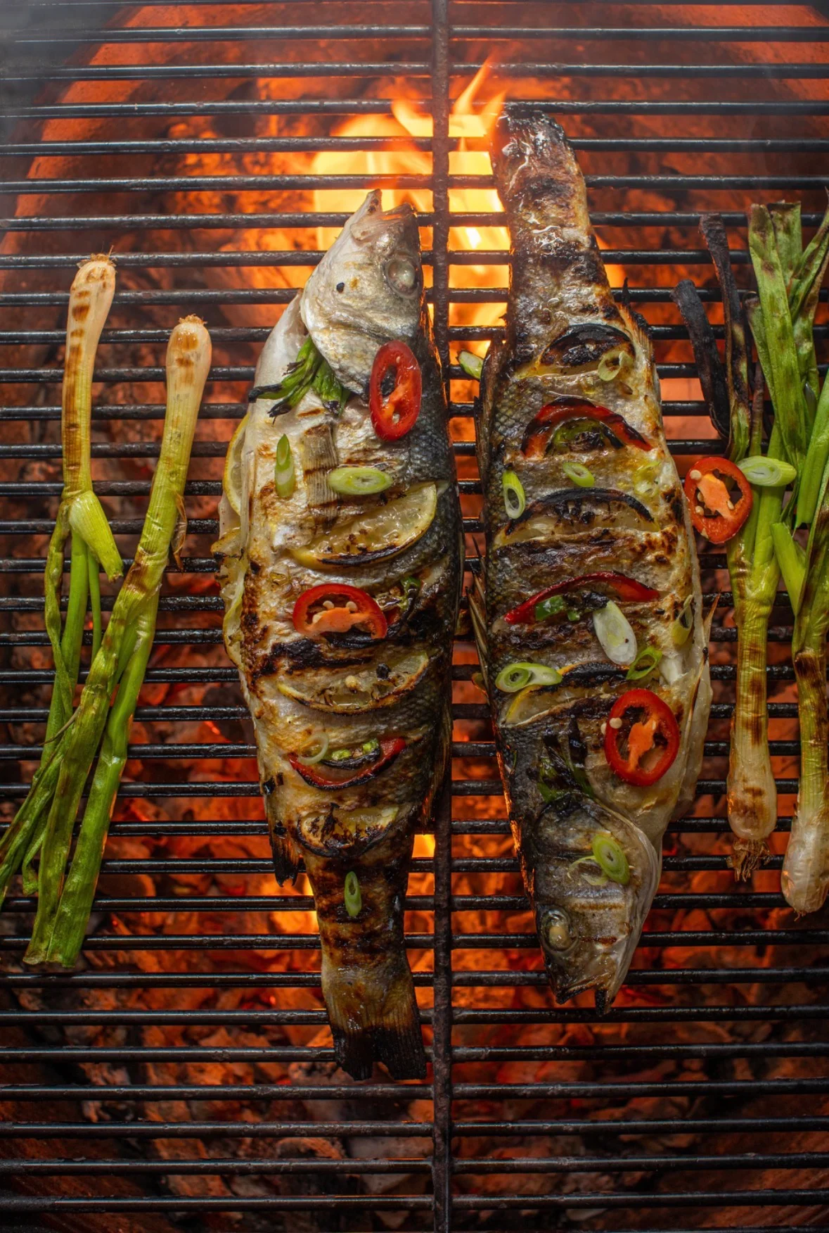 Grilled whole fish with herbs and spices over an open flame