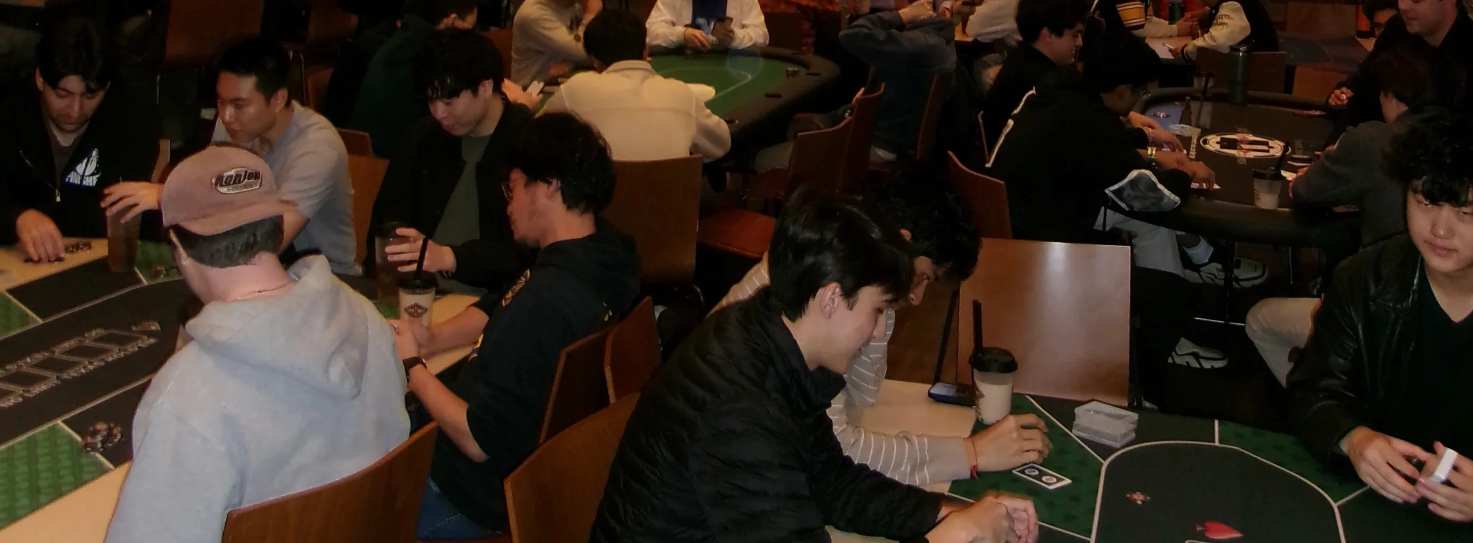 Busy poker room with players at tables