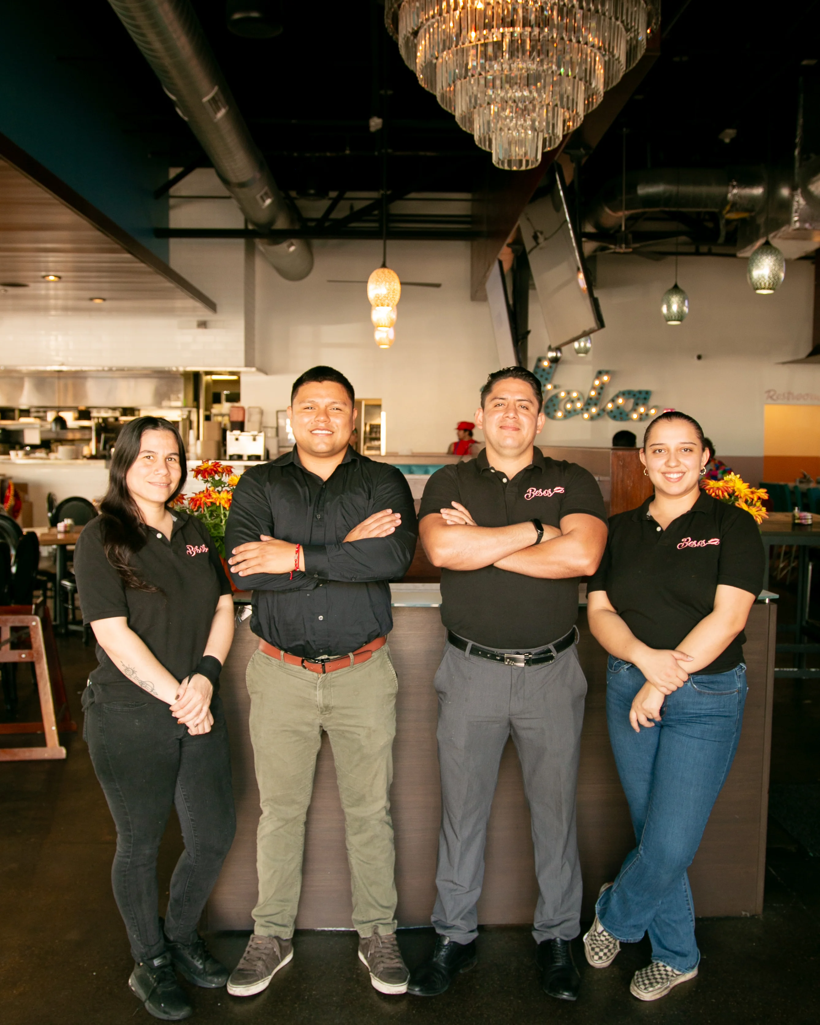 Restaurant staff posing in a vibrant dining area