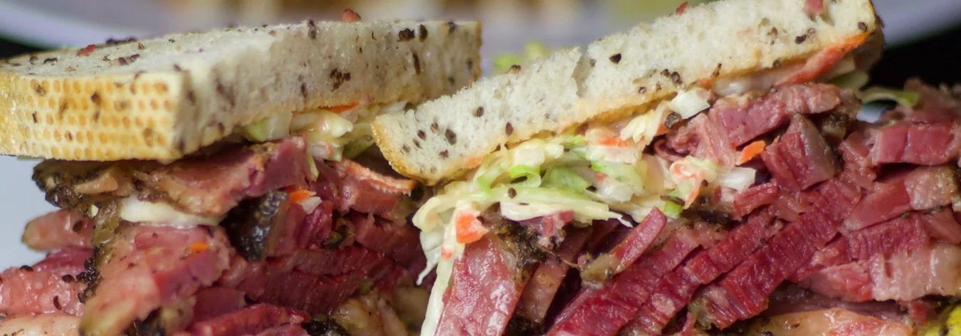 Classic pastrami sandwich on rye bread with coleslaw