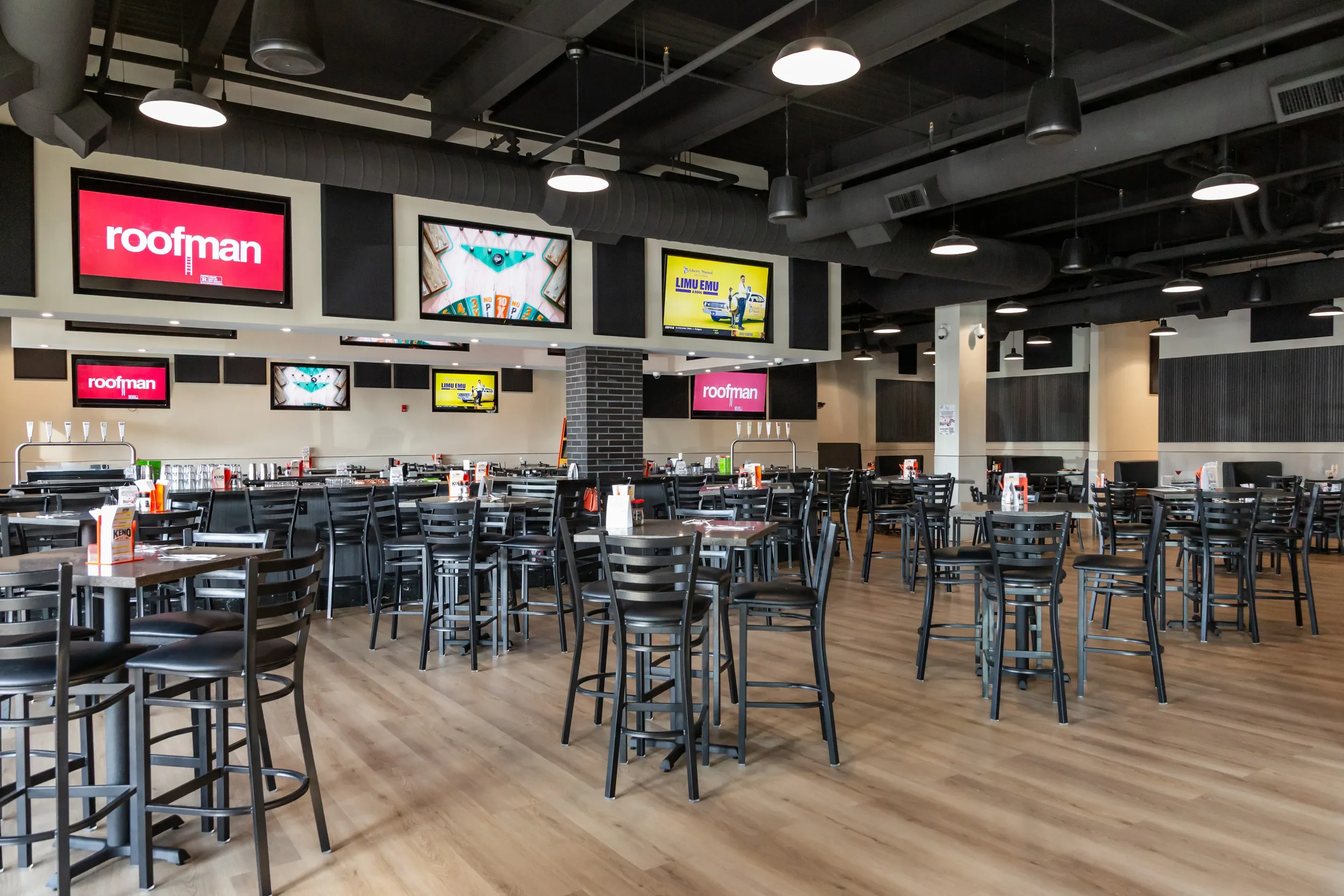 Modern restaurant interior with seating and screens