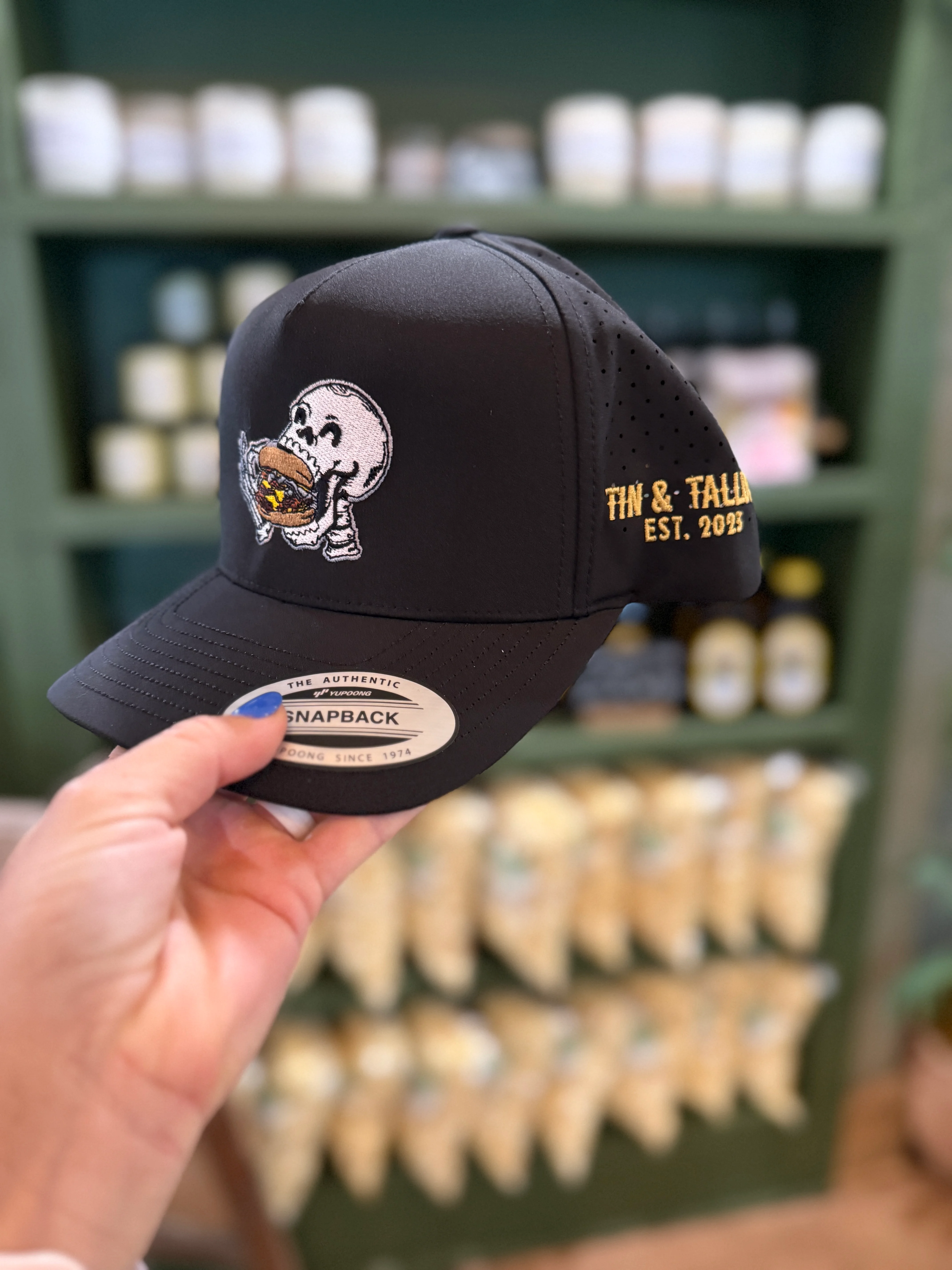 Stylish black snapback hat with unique skull design