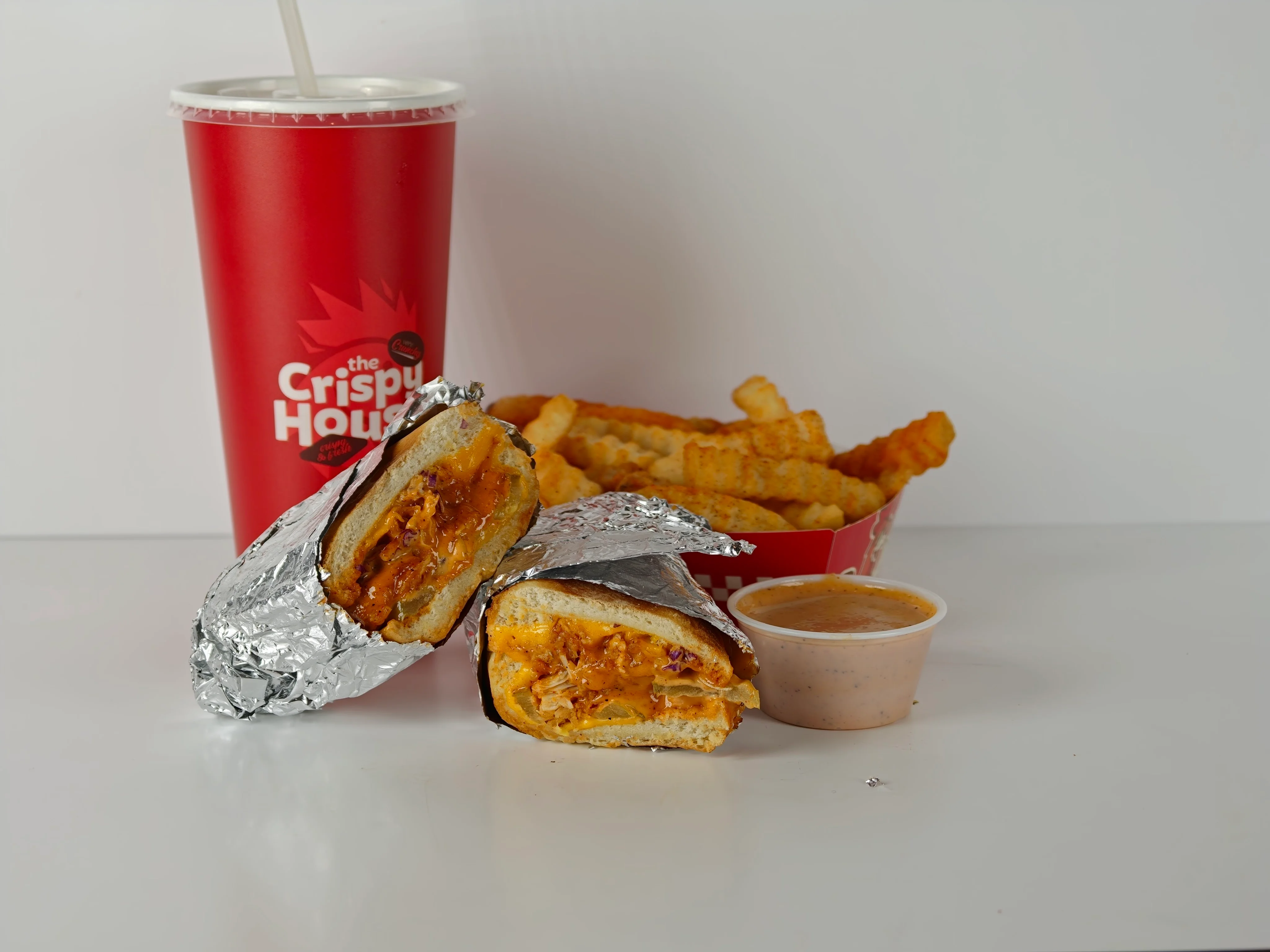 Crispy chicken sandwich with fries and dipping sauce