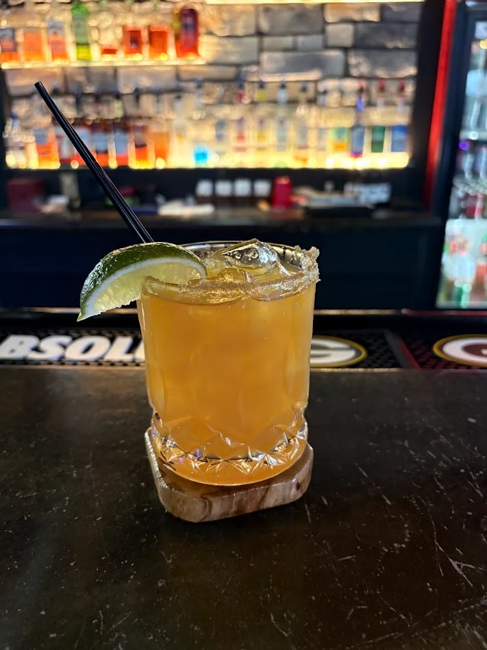 Apple Cider Margarita Garnished with cinnamon sugar and a lime wedge 