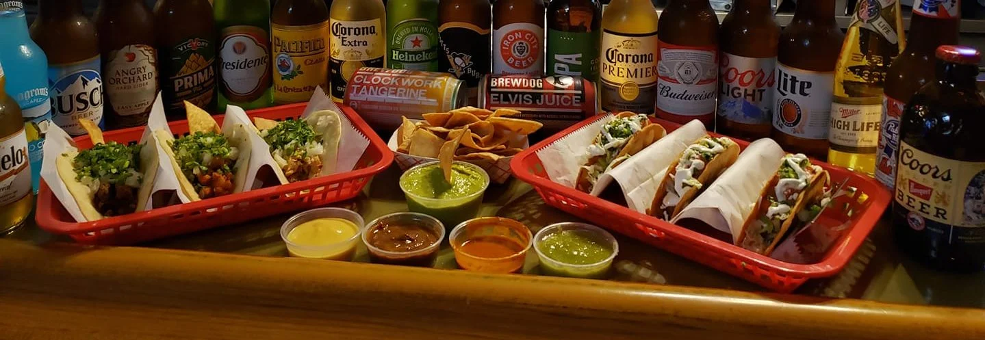 Delicious street tacos with fresh toppings at a vibrant bar