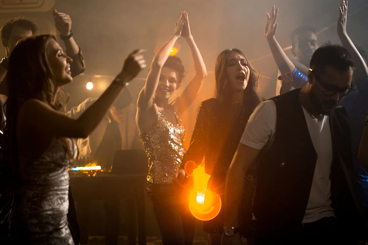 Energetic dance party scene with vibrant lighting