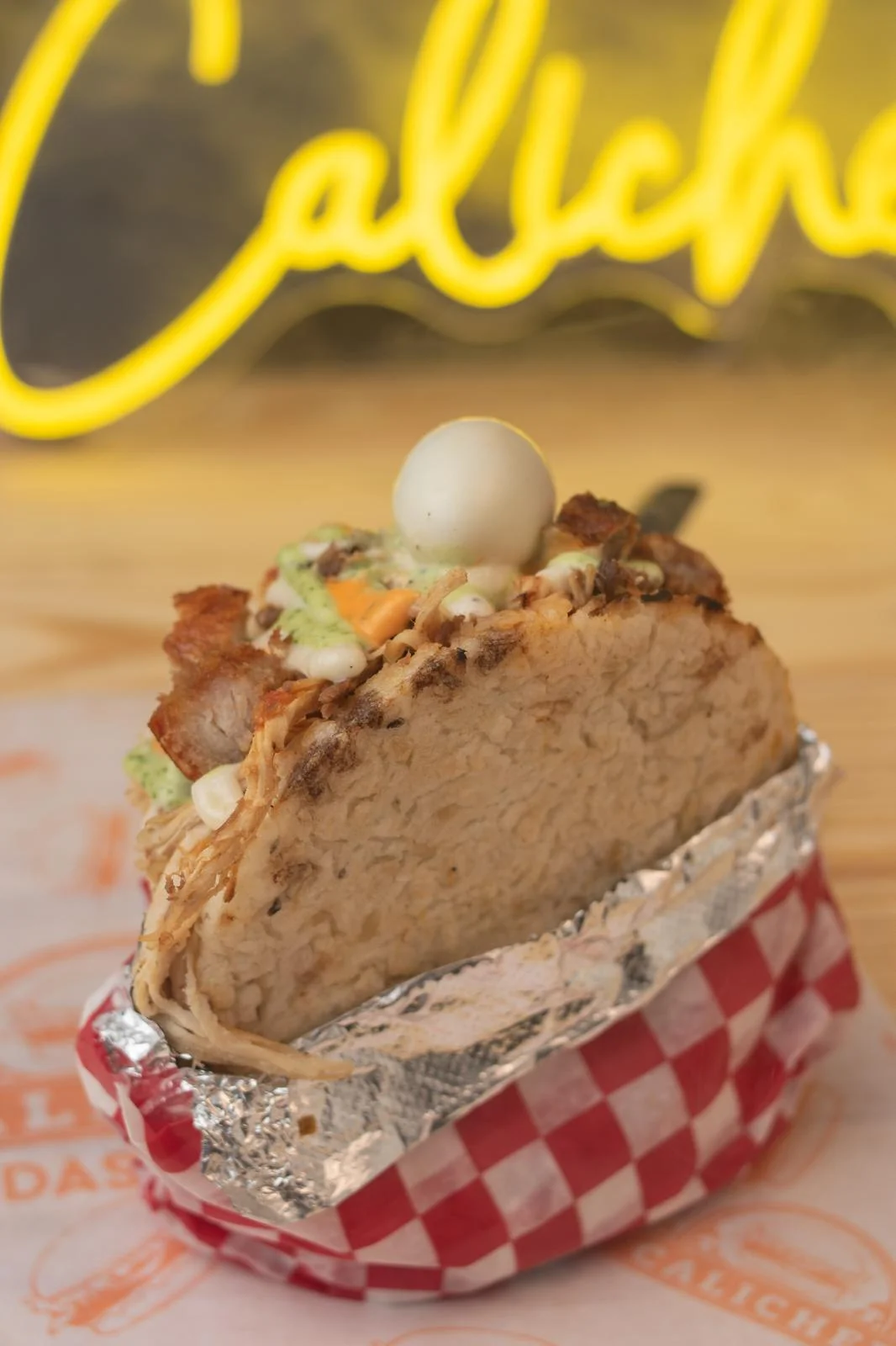 Delicious Mexican taco with savory fillings and a quail egg on top