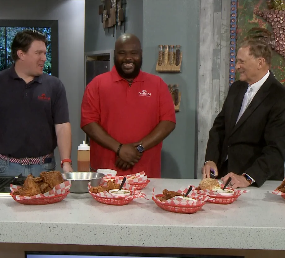 Chefs presenting Southern fried chicken in a cozy restaurant setting