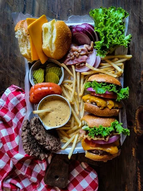 Classic American cheeseburger platter with fries and fresh toppings