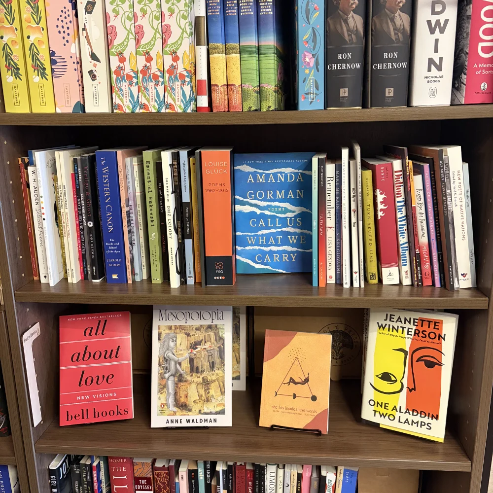 Bookshelf filled with various literary works and poetry collections.