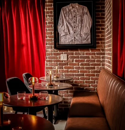 Cozy restaurant interior with red curtains and brick walls