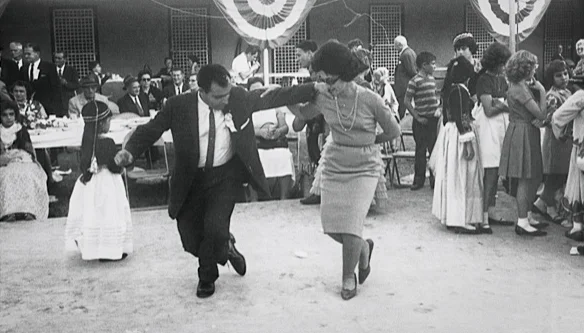 Couple dancing at a lively outdoor celebration