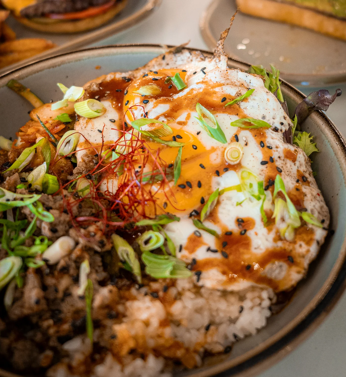 Korean bibimbap topped with a fried egg