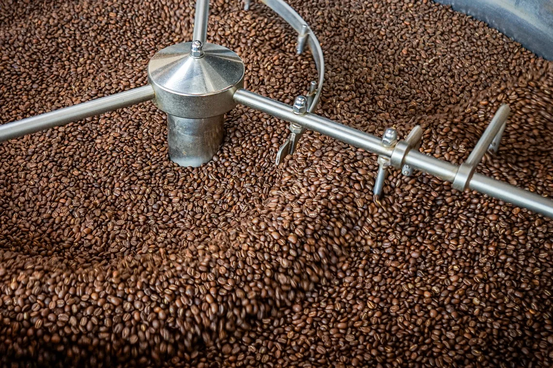 Freshly roasted coffee beans in a roasting machine